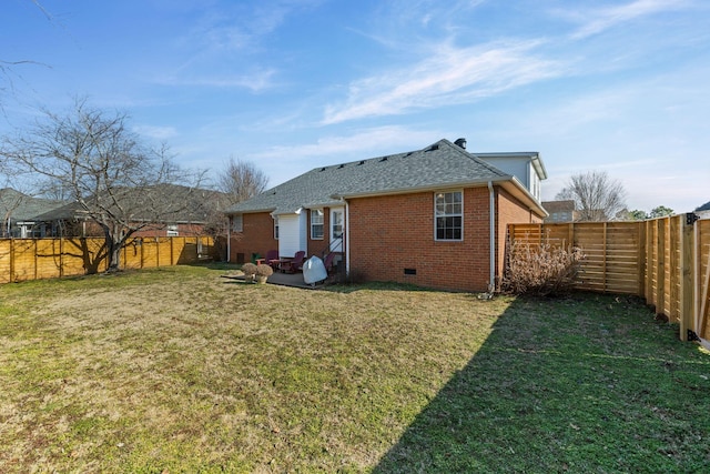 back of house with a lawn