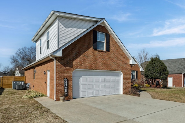 view of property exterior featuring a garage, a yard, and central AC unit