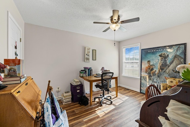 office featuring dark hardwood / wood-style flooring, a textured ceiling, and ceiling fan