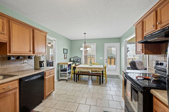 kitchen with backsplash, decorative light fixtures, a chandelier, and black appliances