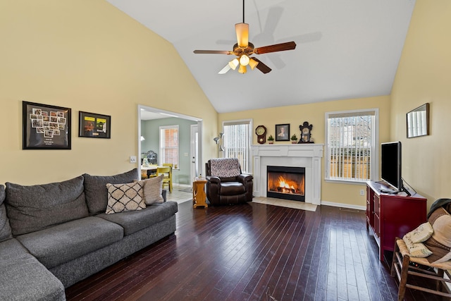 living room featuring hardwood / wood-style flooring, high vaulted ceiling, and ceiling fan