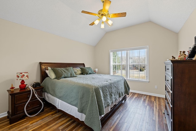 bedroom featuring lofted ceiling, dark wood-type flooring, and ceiling fan