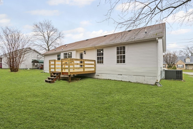 rear view of house with a lawn, a deck, and central air condition unit