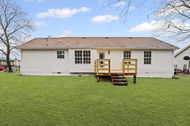 rear view of property with a lawn and a wooden deck