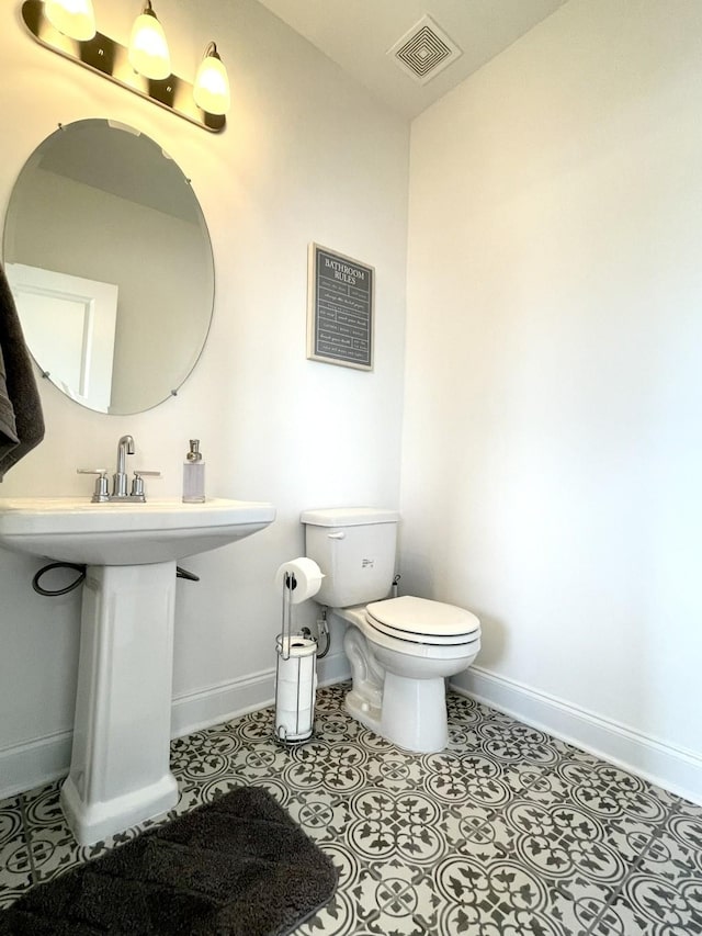 bathroom featuring tile patterned flooring and toilet