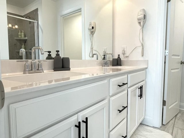 bathroom with a shower with door and vanity