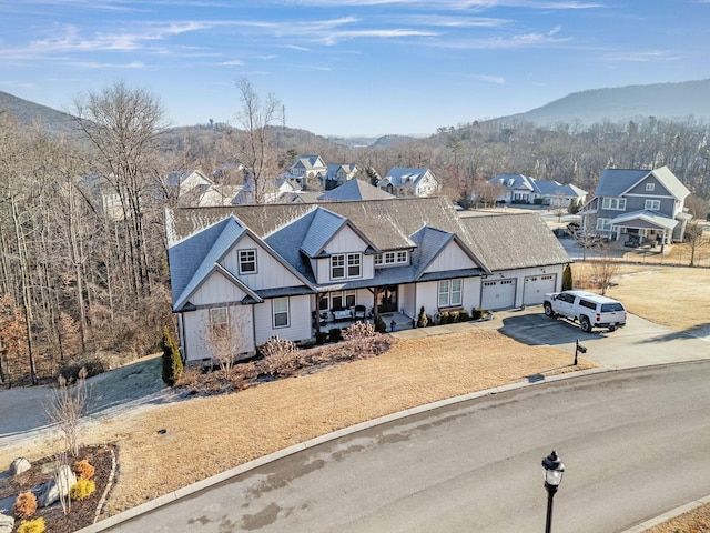 view of front facade featuring a garage, a mountain view, and covered porch