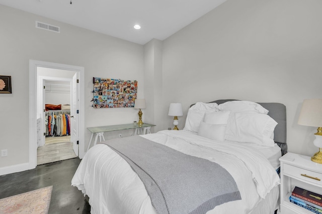 bedroom with a spacious closet and a closet