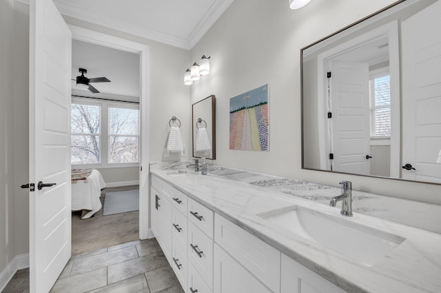 bathroom with crown molding, vanity, and ceiling fan