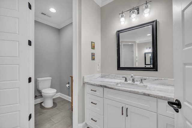 bathroom featuring crown molding, vanity, and toilet