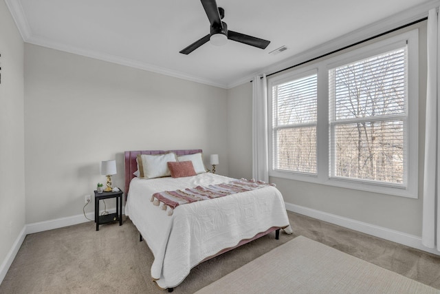 bedroom with ornamental molding, light colored carpet, and ceiling fan