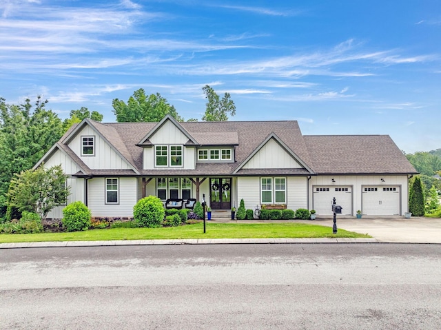 517 Kestrel Ln, Chattanooga, TN 37419 - view of front of home with an attached garage, roof with shingles, driveway, a front lawn, and board and batten siding