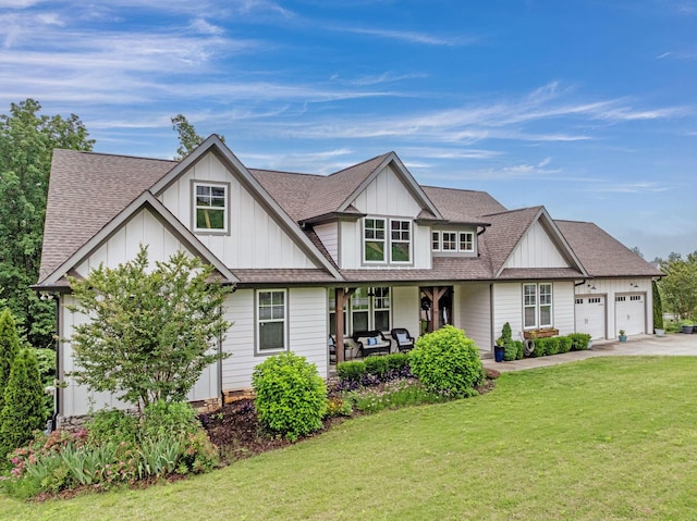 517 Kestrel Ln, Chattanooga, TN 37419 - view of front of home with a front lawn, driveway, board and batten siding, an attached garage, and a porch