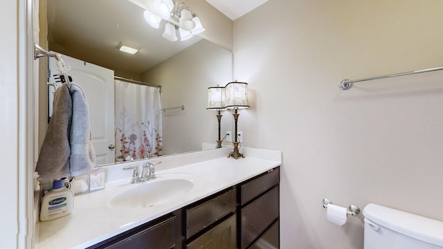 bathroom featuring vanity and toilet