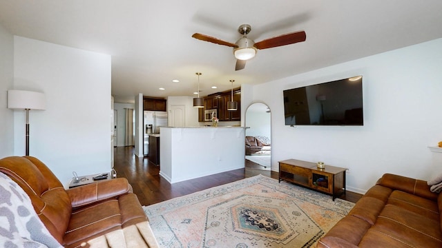 living room featuring dark hardwood / wood-style floors and ceiling fan