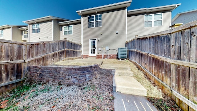 back of property featuring cooling unit and a patio area