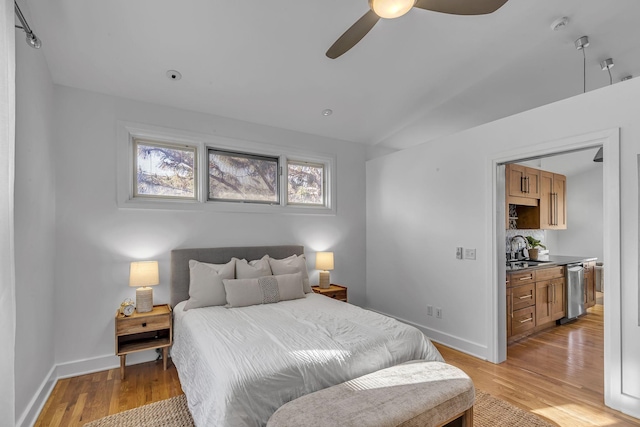 bedroom with sink, ceiling fan, and light wood-type flooring