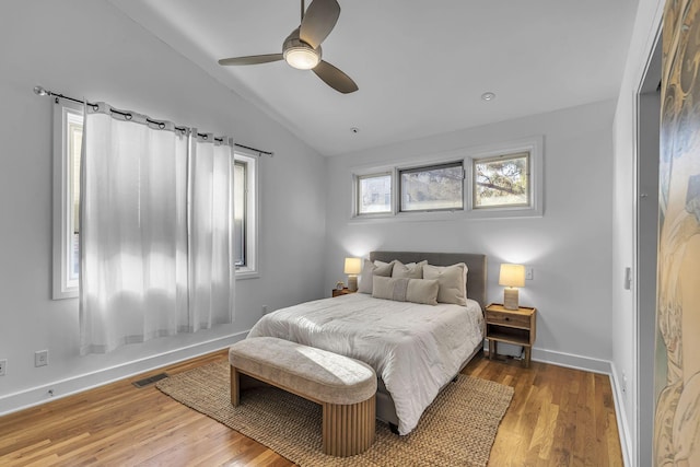 bedroom with hardwood / wood-style flooring, ceiling fan, and vaulted ceiling