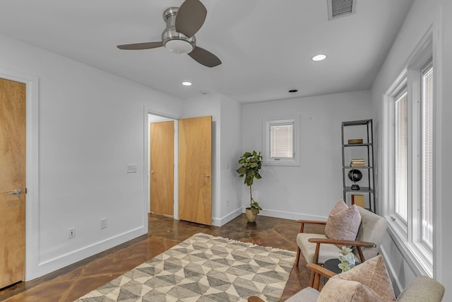 sitting room with a wealth of natural light and ceiling fan