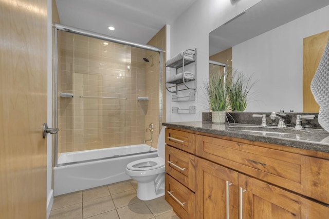 full bathroom featuring tile patterned flooring, enclosed tub / shower combo, vanity, and toilet