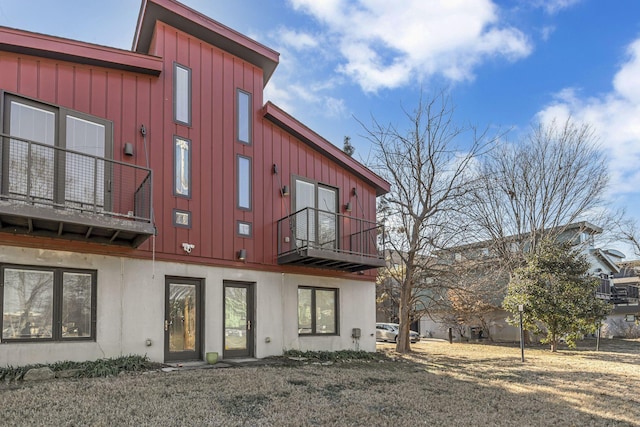 back of property with a balcony