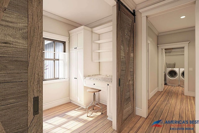 hall with crown molding, a barn door, washer and dryer, and light hardwood / wood-style flooring