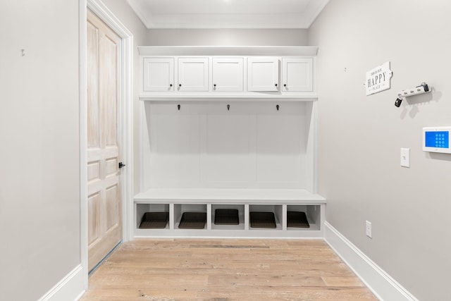 mudroom with crown molding and light hardwood / wood-style flooring