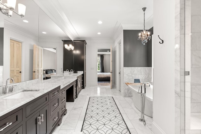 bathroom with vanity, crown molding, a washtub, and a chandelier