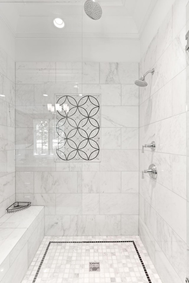 bathroom featuring crown molding and tiled shower