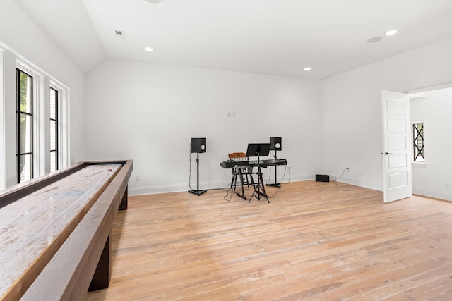 bedroom with vaulted ceiling and light wood-type flooring