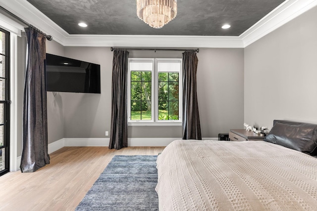 bedroom with ornamental molding and light hardwood / wood-style floors