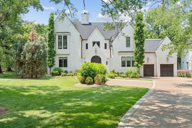 view of front facade featuring a garage and a front lawn