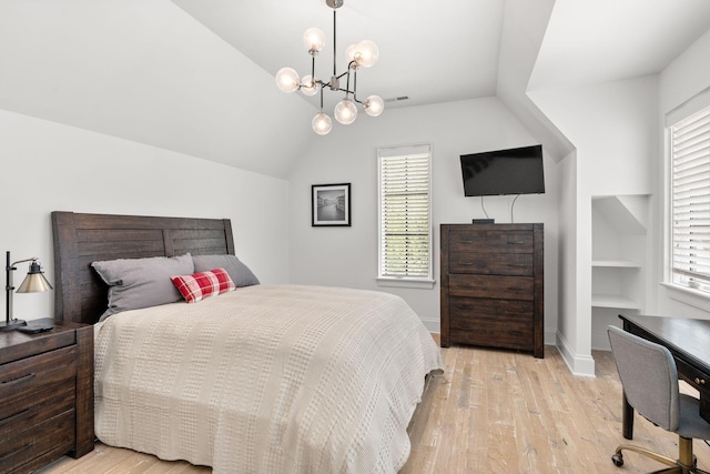 bedroom with lofted ceiling, a chandelier, and light wood-type flooring