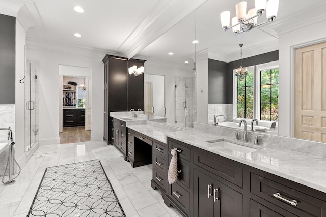 bathroom with vanity, a notable chandelier, crown molding, and a shower with door