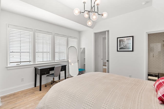 bedroom featuring lofted ceiling, connected bathroom, light hardwood / wood-style flooring, and a chandelier