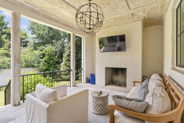 sunroom / solarium with an outdoor brick fireplace, wooden ceiling, and a chandelier