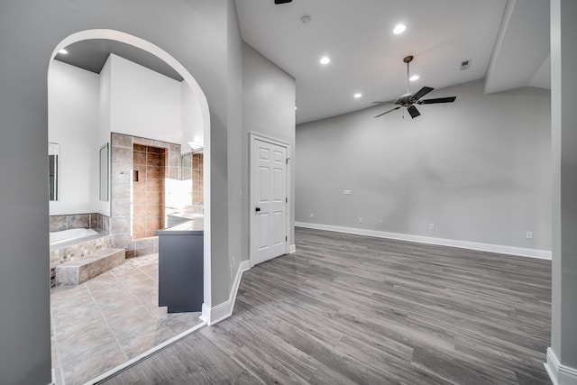 living room featuring wood-type flooring, high vaulted ceiling, and ceiling fan