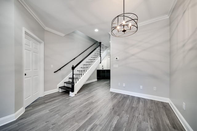 interior space featuring ornamental molding, hardwood / wood-style floors, and a chandelier