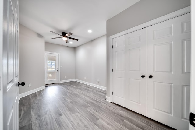 interior space with ceiling fan, a closet, and light hardwood / wood-style flooring