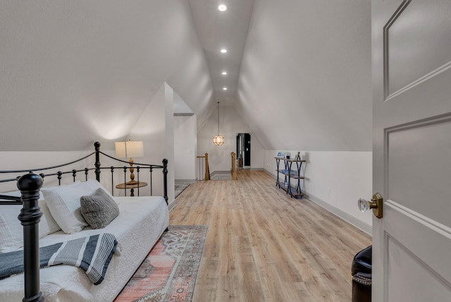 bedroom featuring vaulted ceiling and light hardwood / wood-style floors