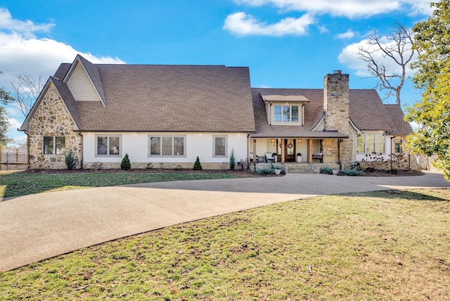 309 Cleveland Ave W, Monterey, TN 38574 - view of front of house with a porch, concrete driveway, a front lawn, and a chimney