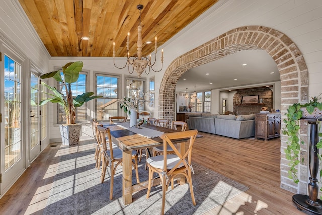 dining room with hardwood / wood-style floors, a notable chandelier, vaulted ceiling, and wooden ceiling