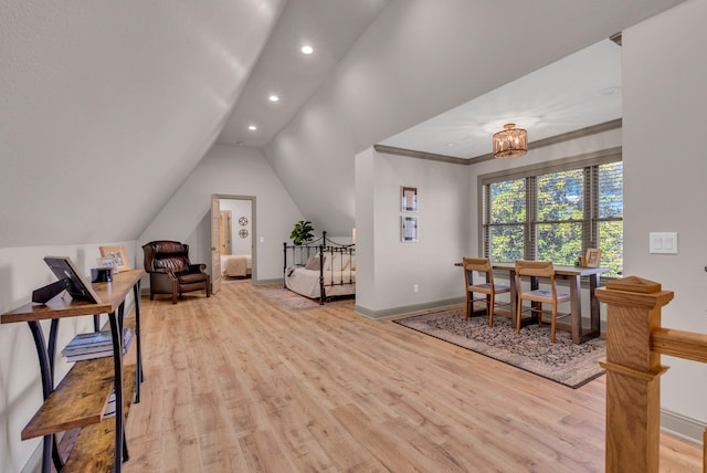 office featuring vaulted ceiling, a notable chandelier, crown molding, and light hardwood / wood-style flooring