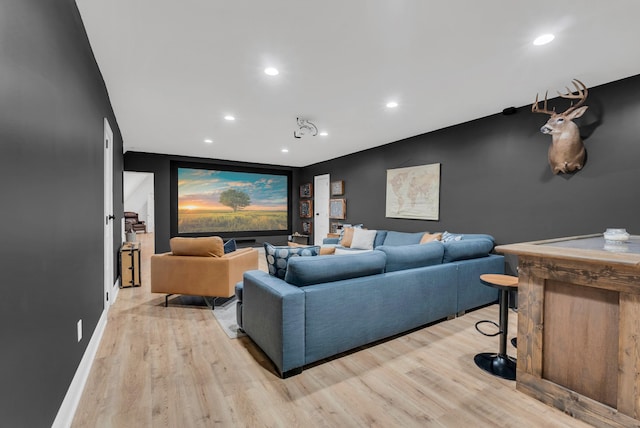 cinema room with light hardwood / wood-style flooring