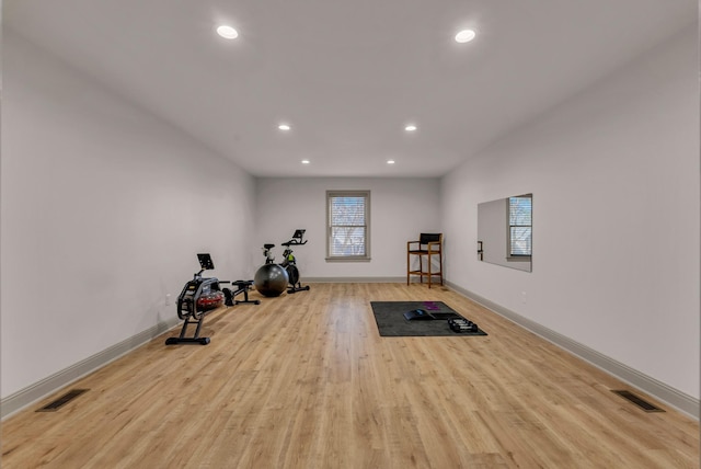 workout room with light hardwood / wood-style floors