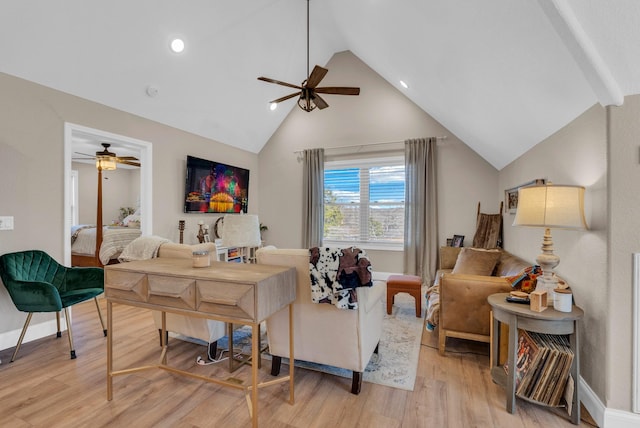 interior space featuring ceiling fan, high vaulted ceiling, and light wood-type flooring