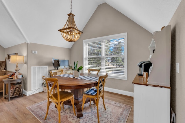 dining space with vaulted ceiling, a chandelier, and light wood-type flooring