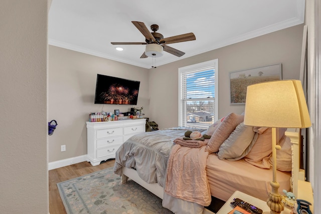 bedroom with crown molding, ceiling fan, and light hardwood / wood-style floors