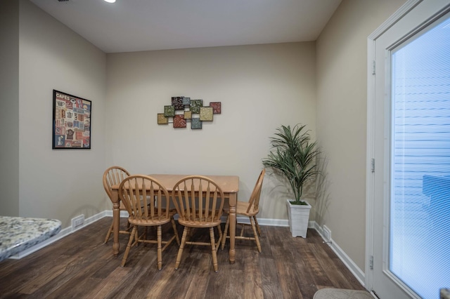 dining area with dark hardwood / wood-style floors