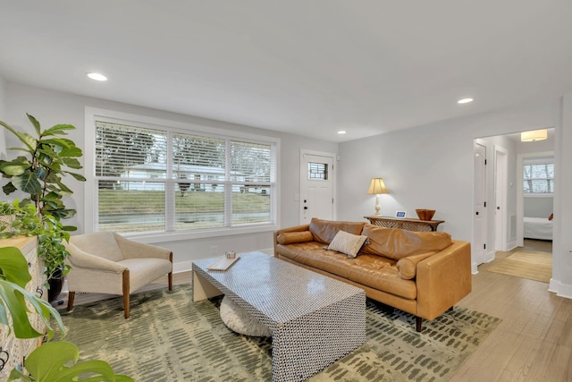 living area featuring recessed lighting, light wood-style flooring, and baseboards